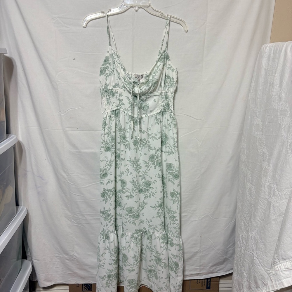 Ivory green floral ruffle trim midi dress with a floral print, smocked waist,